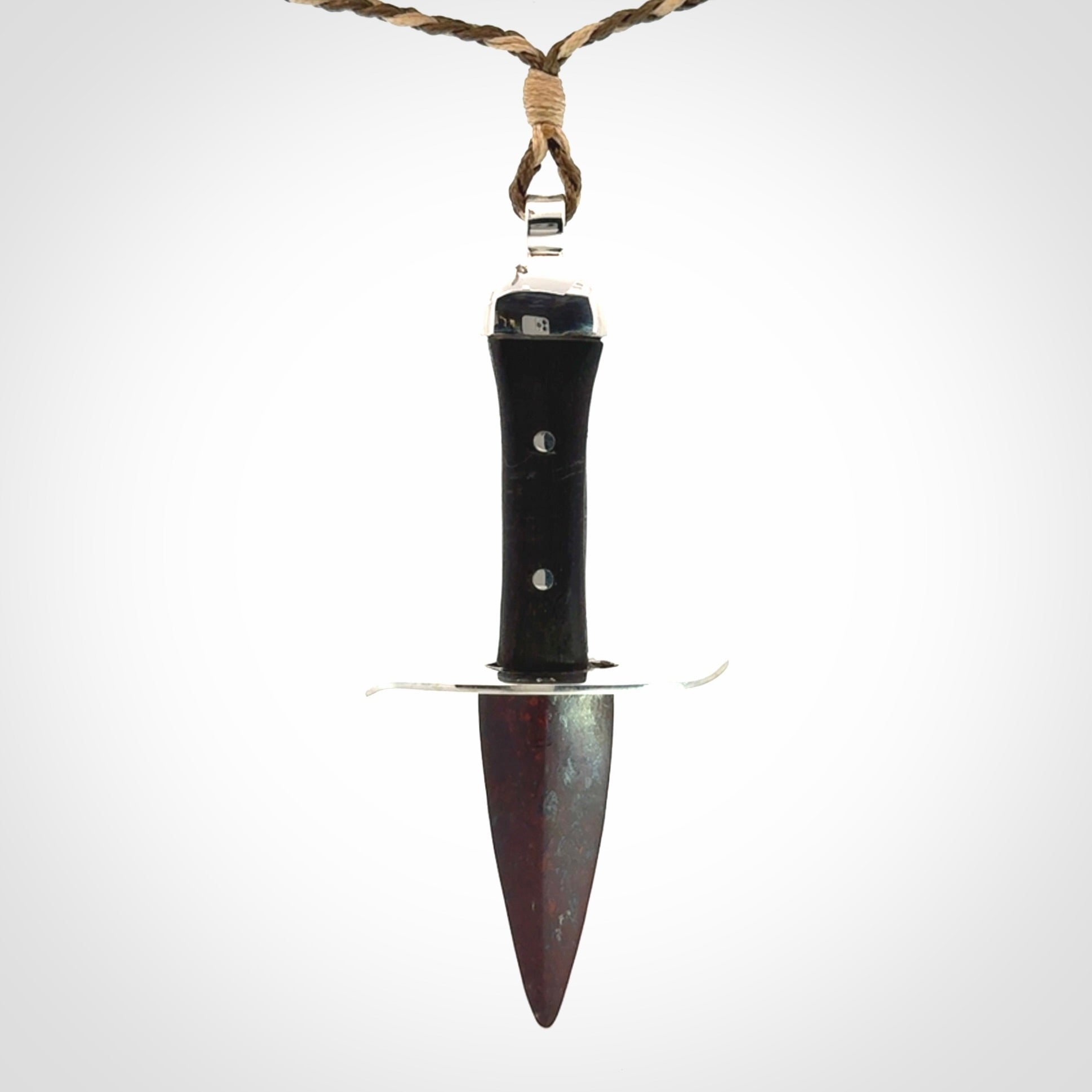 A striking hand carved knife pendant. These are carved with a Red Jasper Stone head and a hardwood handle. The cords are hand plaited in our waxed polyester which is robust, strong and durable. We ship these worldwide with express courier.