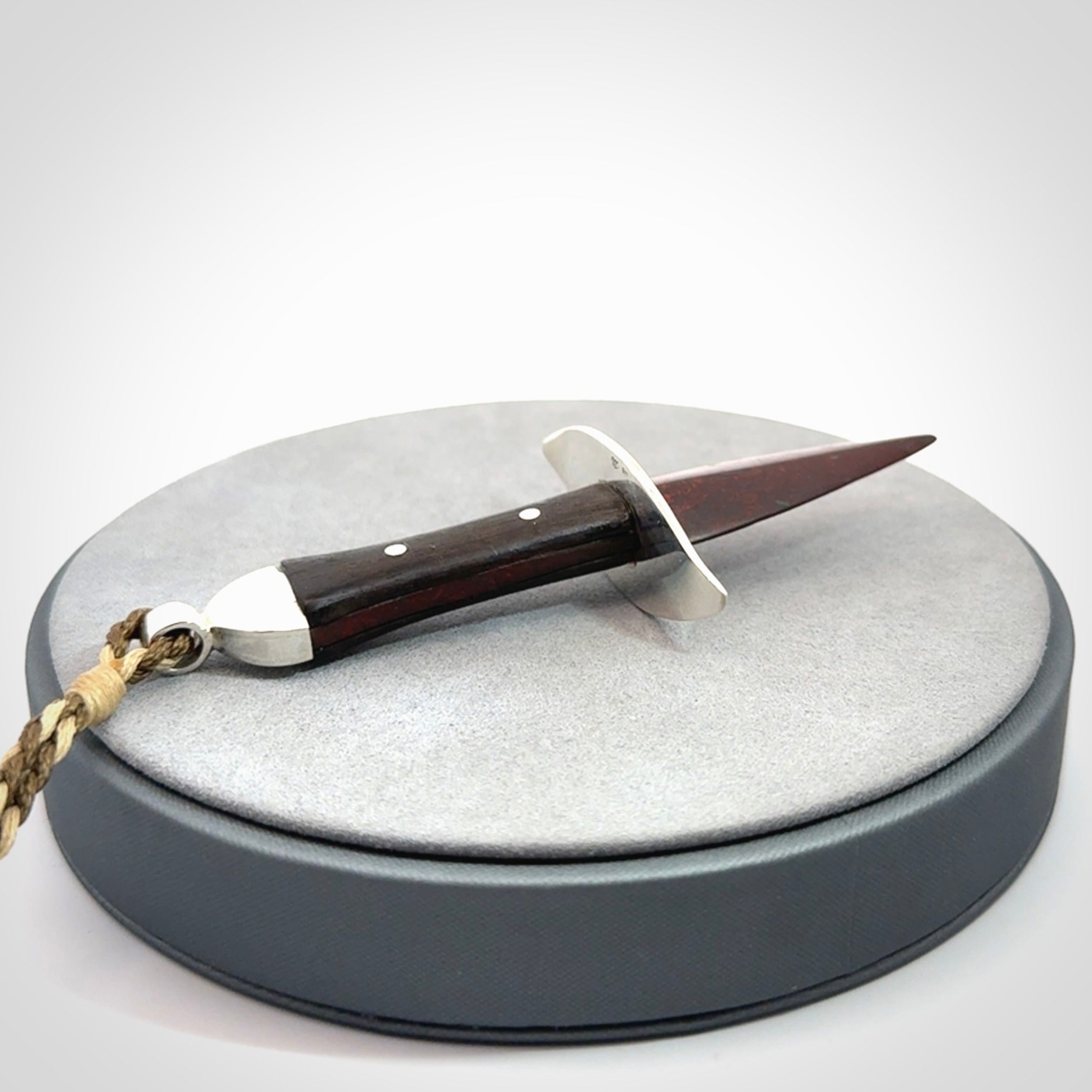 A striking hand carved knife pendant. These are carved with a Red Jasper Stone head and a hardwood handle. The cords are hand plaited in our waxed polyester which is robust, strong and durable. We ship these worldwide with express courier.