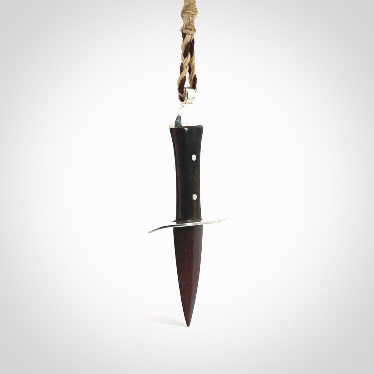 A striking hand carved knife pendant. These are carved with a Red Jasper Stone head and a hardwood handle. The cords are hand plaited in our waxed polyester which is robust, strong and durable. We ship these worldwide with express courier.