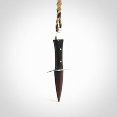 A striking hand carved knife pendant. These are carved with a Red Jasper Stone head and a hardwood handle. The cords are hand plaited in our waxed polyester which is robust, strong and durable. We ship these worldwide with express courier.