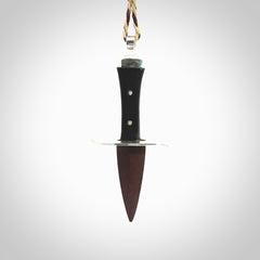 A striking hand carved knife pendant. These are carved with a Red Jasper Stone head and a hardwood handle. The cords are hand plaited in our waxed polyester which is robust, strong and durable. We ship these worldwide with express courier.