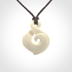Hand carved bone twist pendant hand made by Peter Mitchell in New Zealand. This bone twist is provided with an adjustable brown cord and packaged in a woven kete pouch.