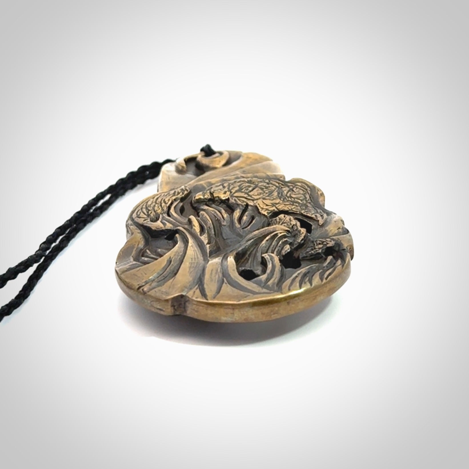 A beautiful hand made, bronze tiki pendant.