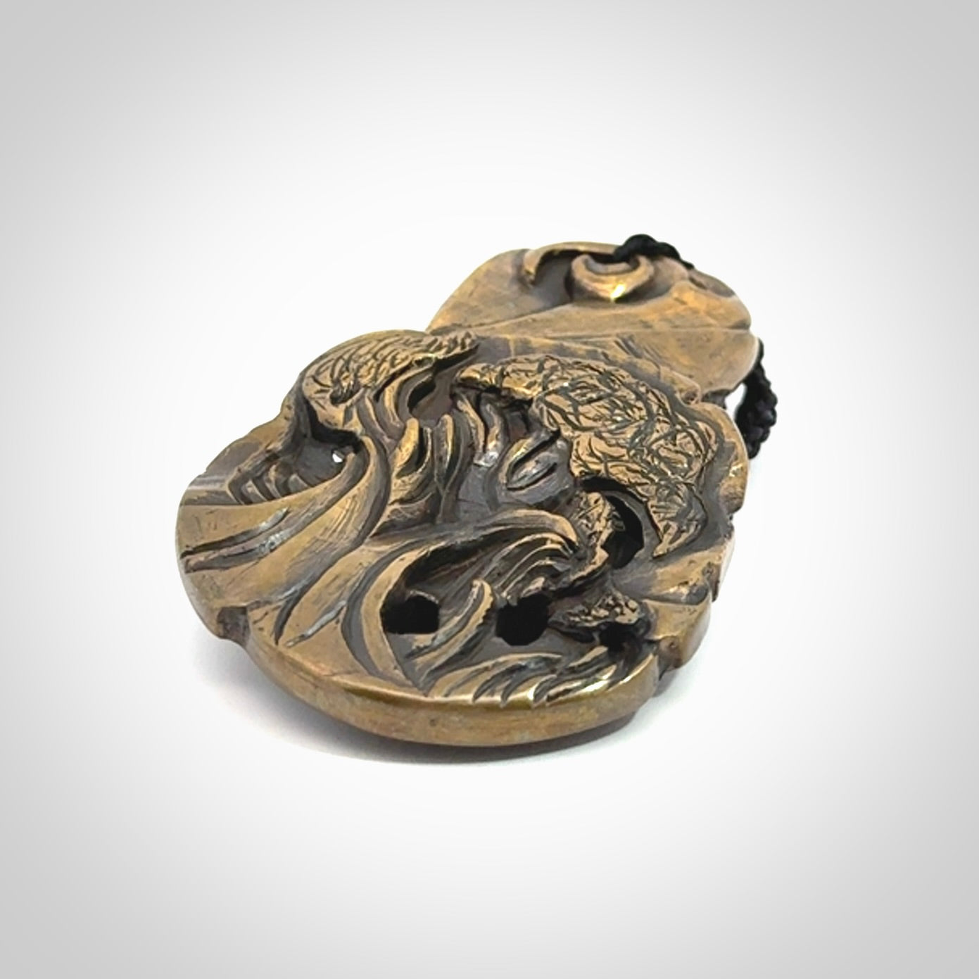 A beautiful hand made, bronze tiki pendant.