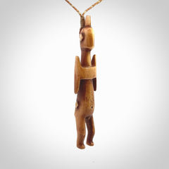 POKERFACE - a traditional Gambier Island figurine, carved as a pendant. This piece was hand carved for us by Yuri Terenyi. This is a work of art and is a collectable piece of traditional bone carving. It can be worn as a special piece of jewellery or displayed. This is art made to wear at its finest.