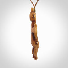 POKERFACE - a traditional Gambier Island figurine, carved as a pendant. This piece was hand carved for us by Yuri Terenyi. This is a work of art and is a collectable piece of traditional bone carving. It can be worn as a special piece of jewellery or displayed. This is art made to wear at its finest.