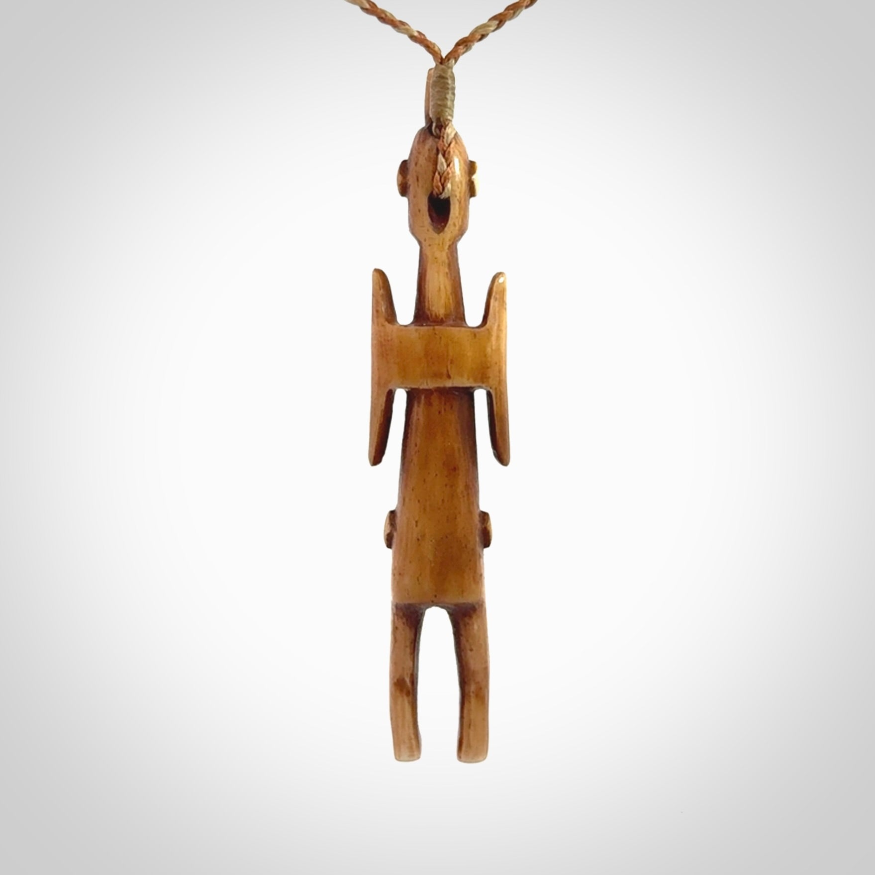 POKERFACE - a traditional Gambier Island figurine, carved as a pendant. This piece was hand carved for us by Yuri Terenyi. This is a work of art and is a collectable piece of traditional bone carving. It can be worn as a special piece of jewellery or displayed. This is art made to wear at its finest.