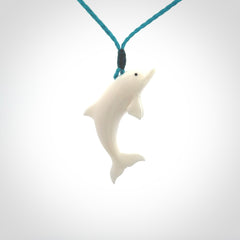 Hand made Bone dolphin pendant carved for men and women. Hand carved Bone dolphin with adjustable cord. Gifts for lovers of dolphins and art to wear. Free delivery worldwide.