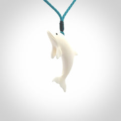 Hand made Bone dolphin pendant carved for men and women. Hand carved Bone dolphin with adjustable cord. Gifts for lovers of dolphins and art to wear. Free delivery worldwide.