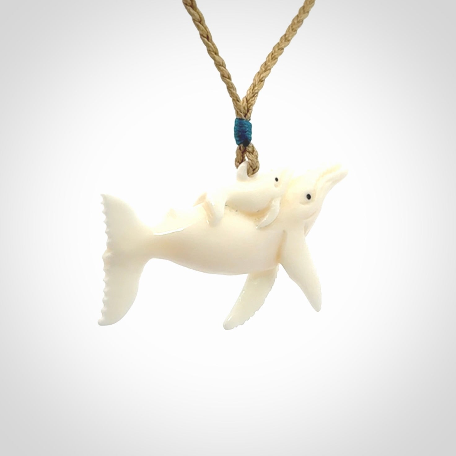 Hand carved bone whale and whale calf pendant
