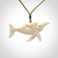 Hand carved bone whale and whale calf pendant