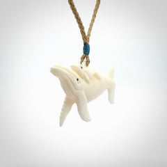 Hand carved bone whale and whale calf pendant