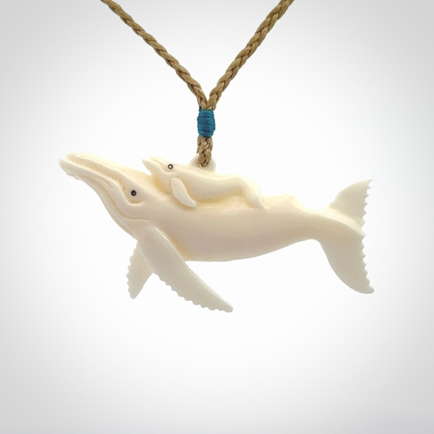 Hand carved bone whale and whale calf pendant