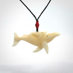 Hand carved bone whale and whale calf pendant