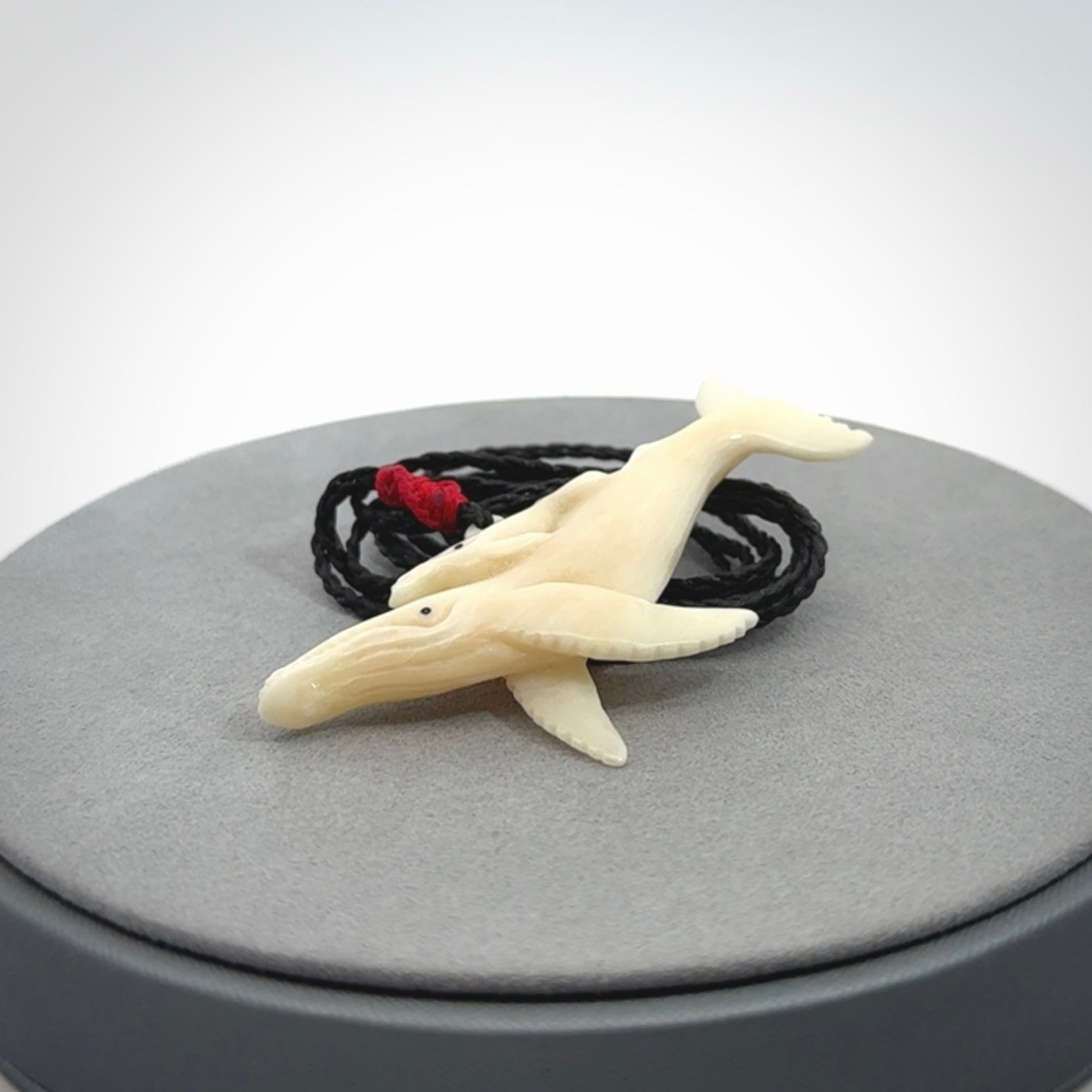 Hand carved bone whale and whale calf pendant