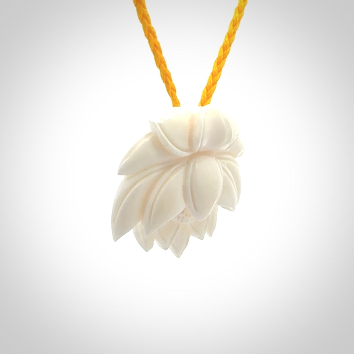 This is a hand carved lotus flower pendant. It is made from bone. This is a medium sized necklace and is a very unique pendant and is a wonderful necklace to wear. Hand carved bone lotus flower pendant with adjustable cord.