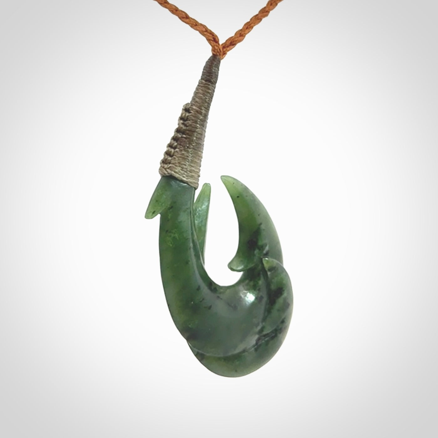 Hand carved double Jade matau hook pendant. The cord is length adjustable.