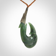 Hand carved double Jade matau hook pendant. The cord is length adjustable.