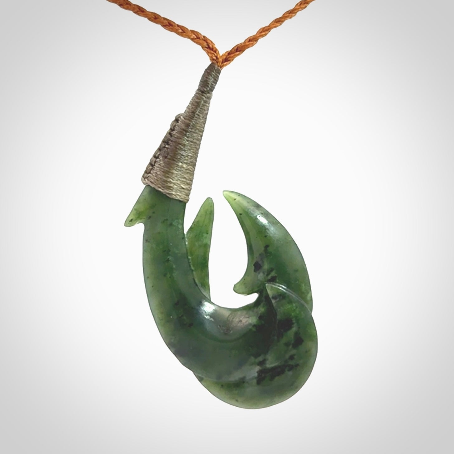 Hand carved double Jade matau hook pendant. The cord is length adjustable.