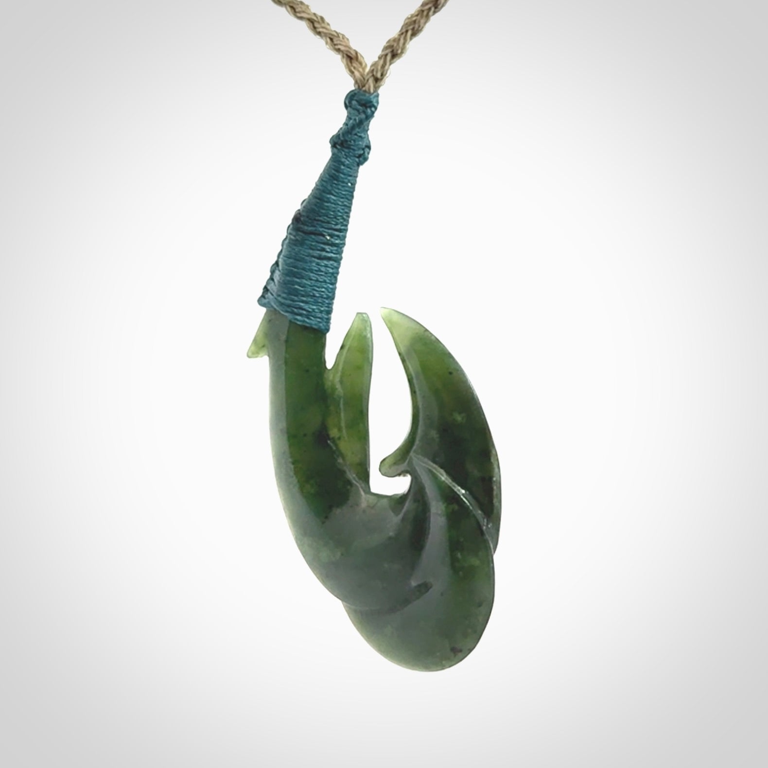 Hand carved double Jade matau hook pendant. The cord is length adjustable.