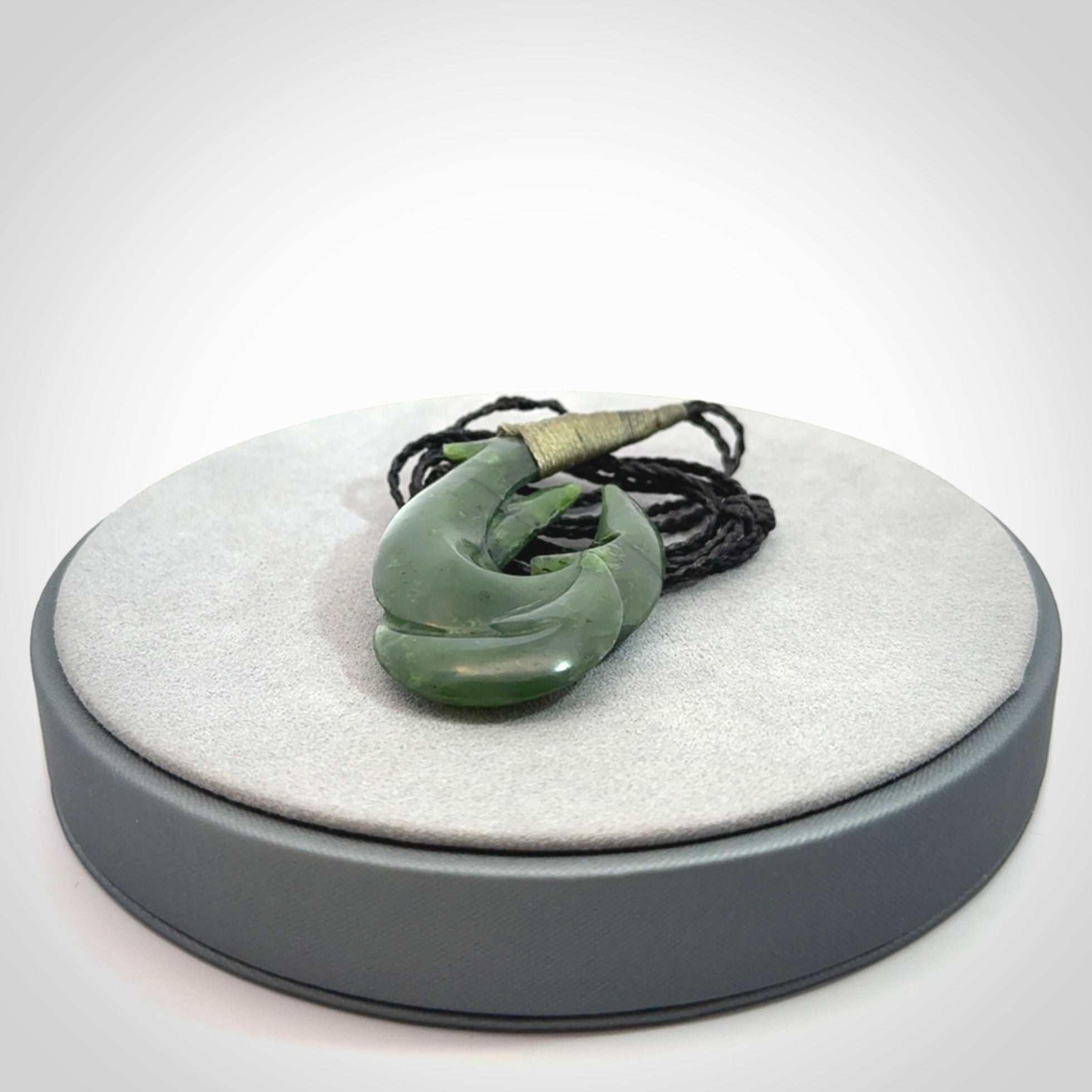 Hand carved double Jade matau hook pendant. The cord is length adjustable.