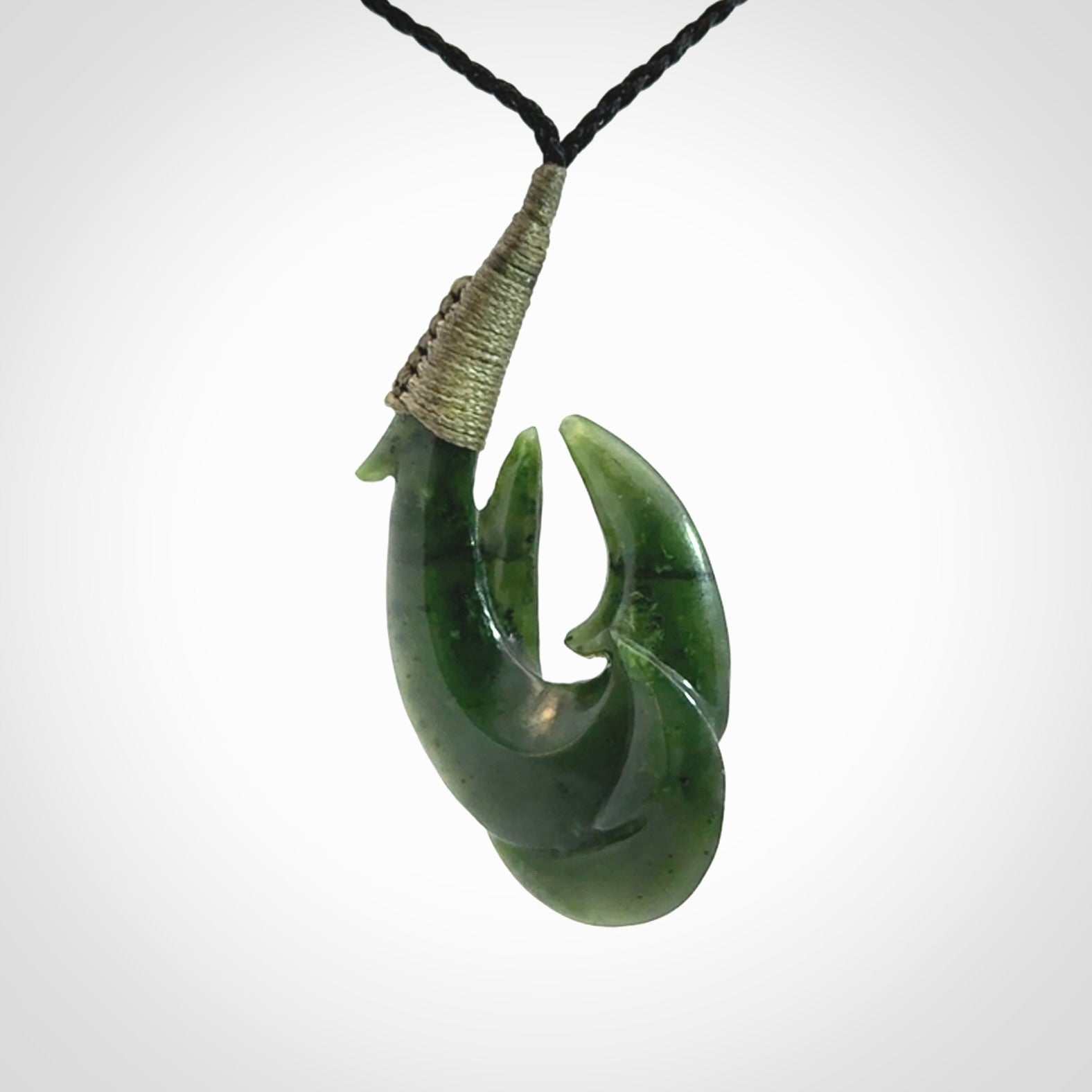 Hand carved double Jade matau hook pendant. The cord is length adjustable.