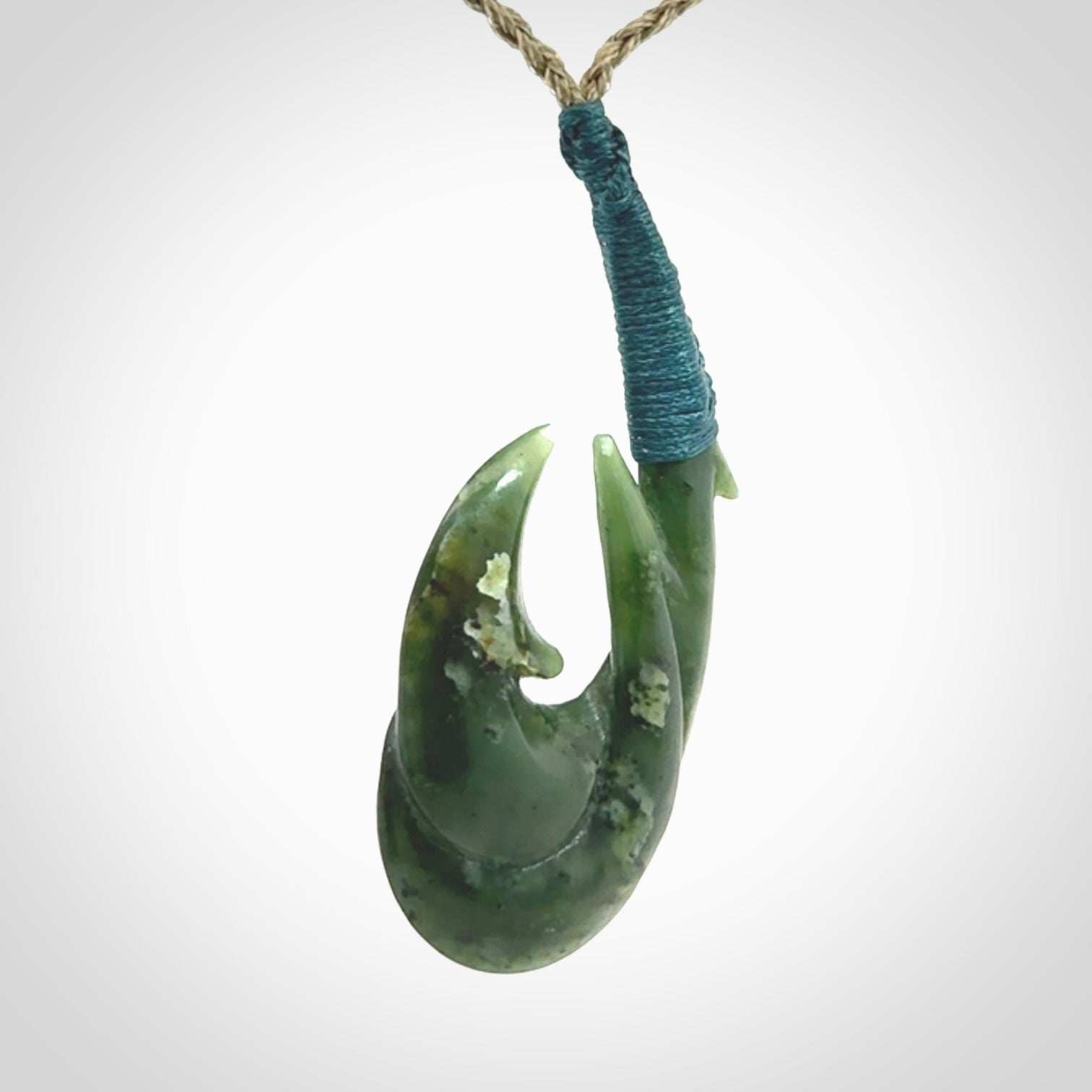 Hand carved double Jade matau hook pendant. The cord is length adjustable.