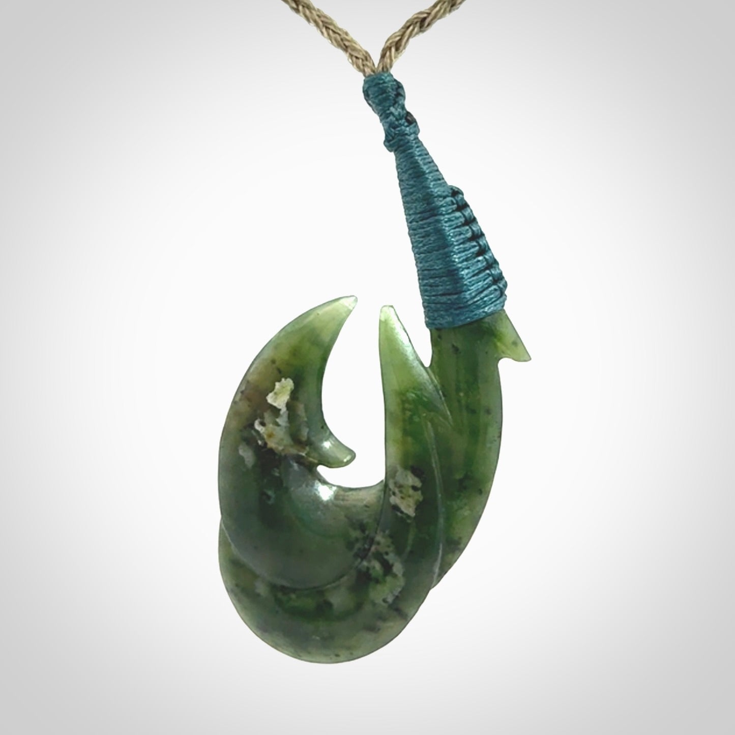 Hand carved double Jade matau hook pendant. The cord is length adjustable.