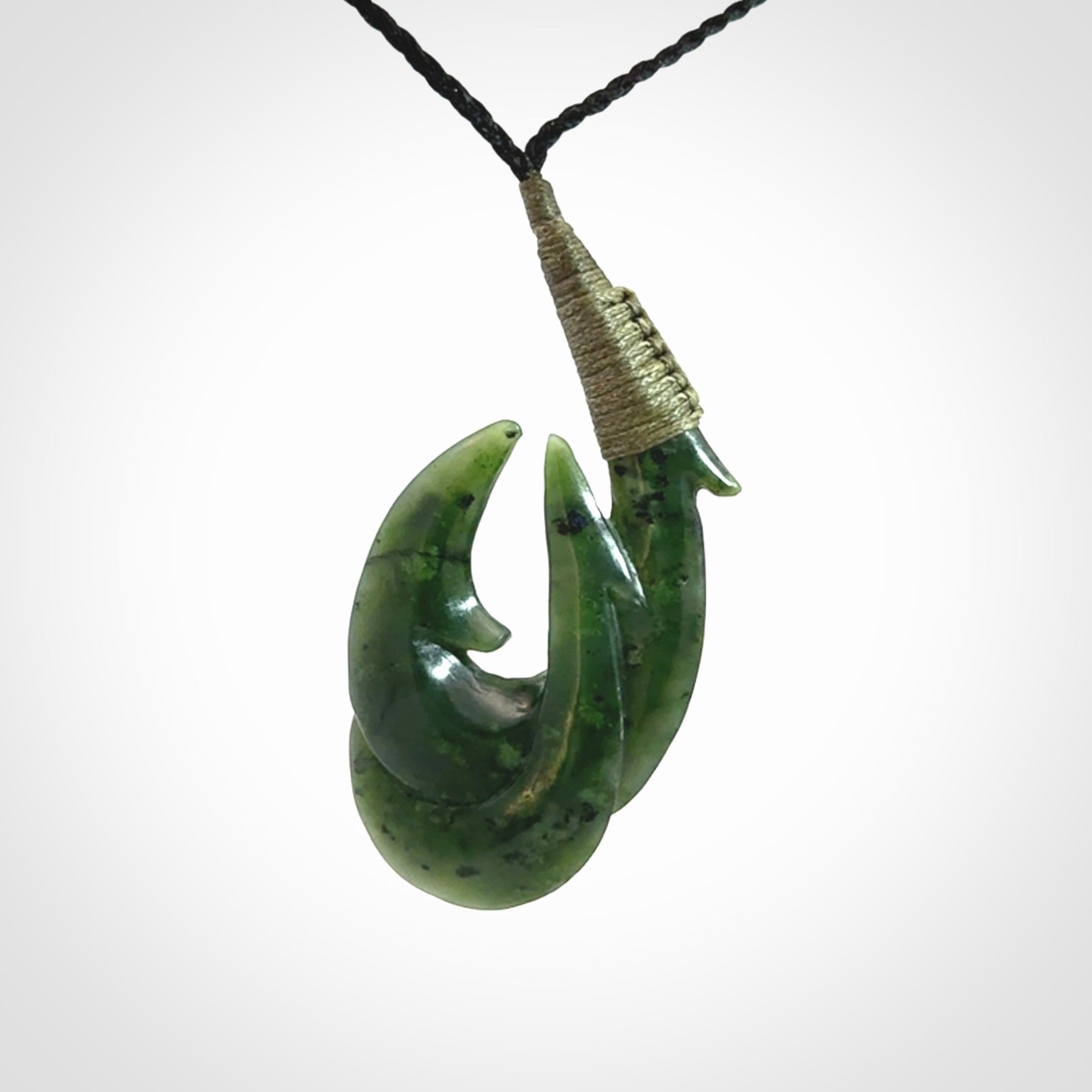 Hand carved double Jade matau hook pendant. The cord is length adjustable.