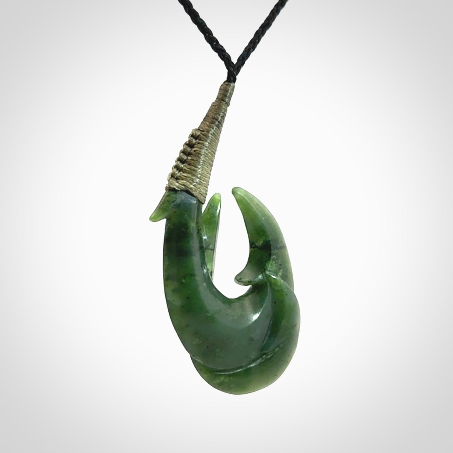 Hand carved double Jade matau hook pendant. The cord is length adjustable.
