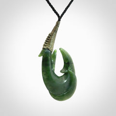 Hand carved double Jade matau hook pendant. The cord is length adjustable.