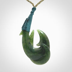 Hand carved double Jade matau hook pendant. The cord is length adjustable.