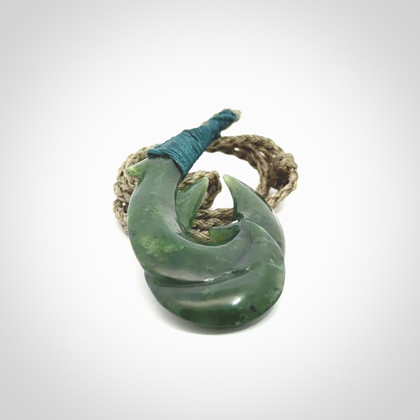 Hand carved double Jade matau hook pendant. The cord is length adjustable.
