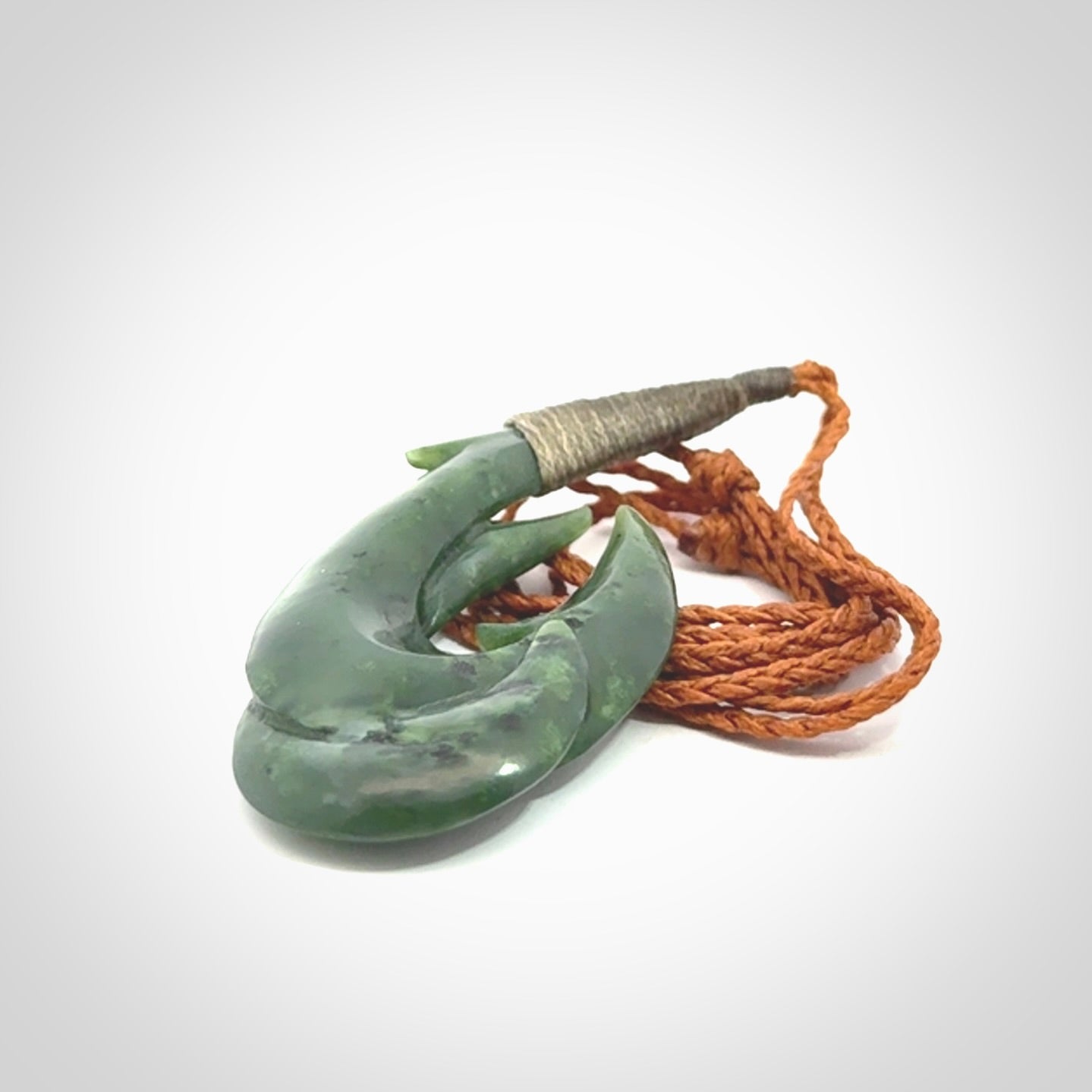 Hand carved double Jade matau hook pendant. The cord is length adjustable.
