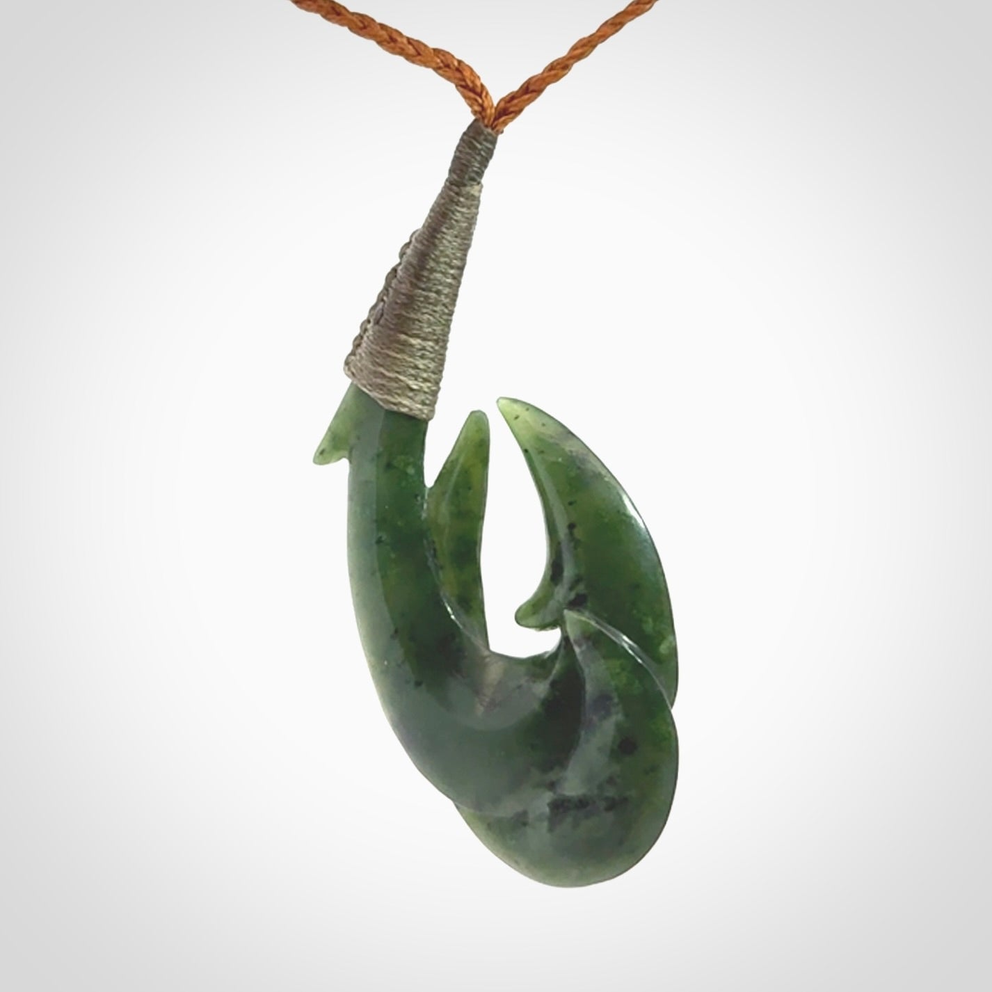Hand carved double Jade matau hook pendant. The cord is length adjustable.