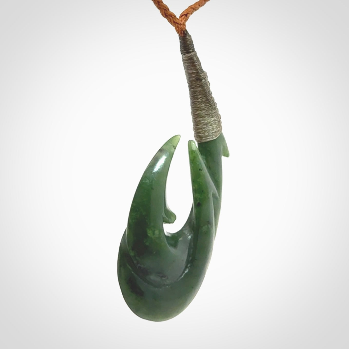Hand carved double Jade matau hook pendant. The cord is length adjustable.