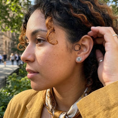 Woman wearing bone earrings