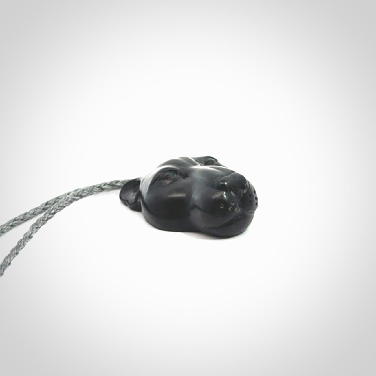 This pendant is a hand carved puma. We've carved this from a lovely piece of black jade and we provide it with a hand plaited cord. Shipping is free worldwide.