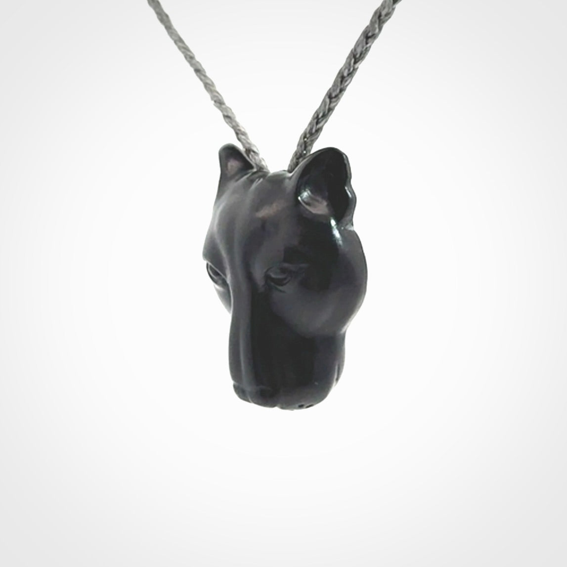 This pendant is a hand carved puma. We've carved this from a lovely piece of black jade and we provide it with a hand plaited cord. Shipping is free worldwide.