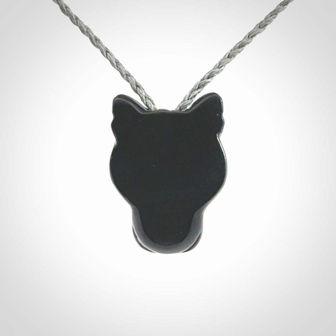 This pendant is a hand carved puma. We've carved this from a lovely piece of black jade and we provide it with a hand plaited cord. Shipping is free worldwide.