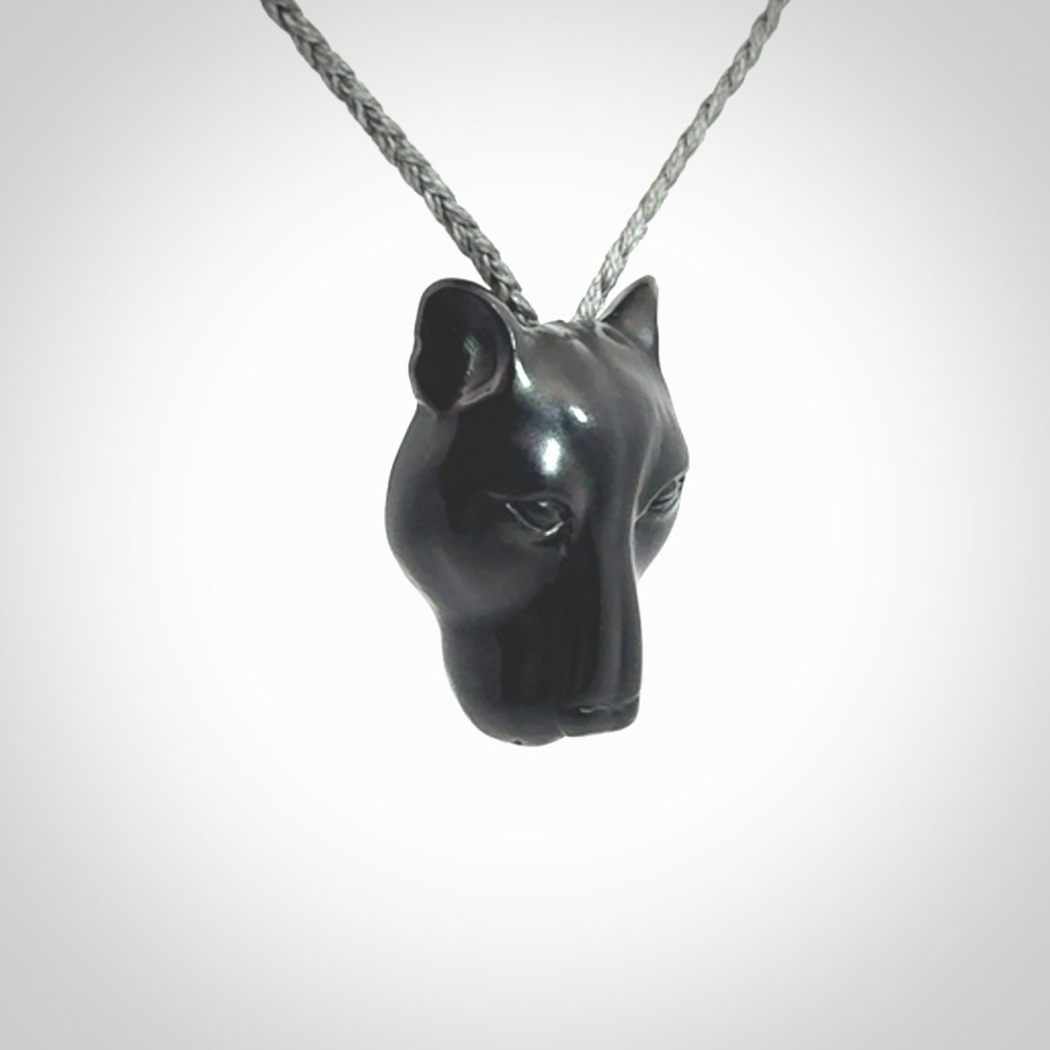 This pendant is a hand carved puma. We've carved this from a lovely piece of black jade and we provide it with a hand plaited cord. Shipping is free worldwide.