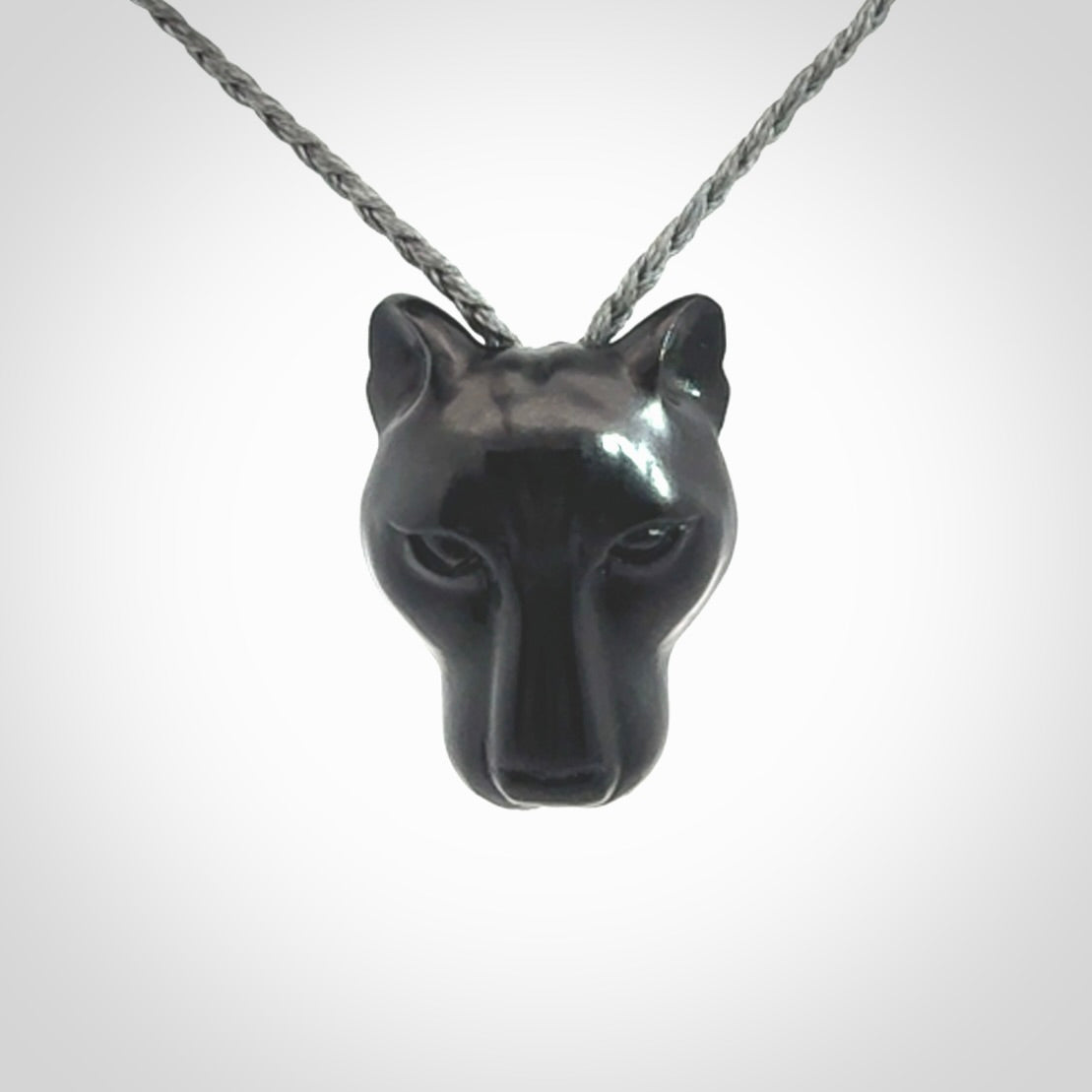 This pendant is a hand carved puma. We've carved this from a lovely piece of black jade and we provide it with a hand plaited cord. Shipping is free worldwide.