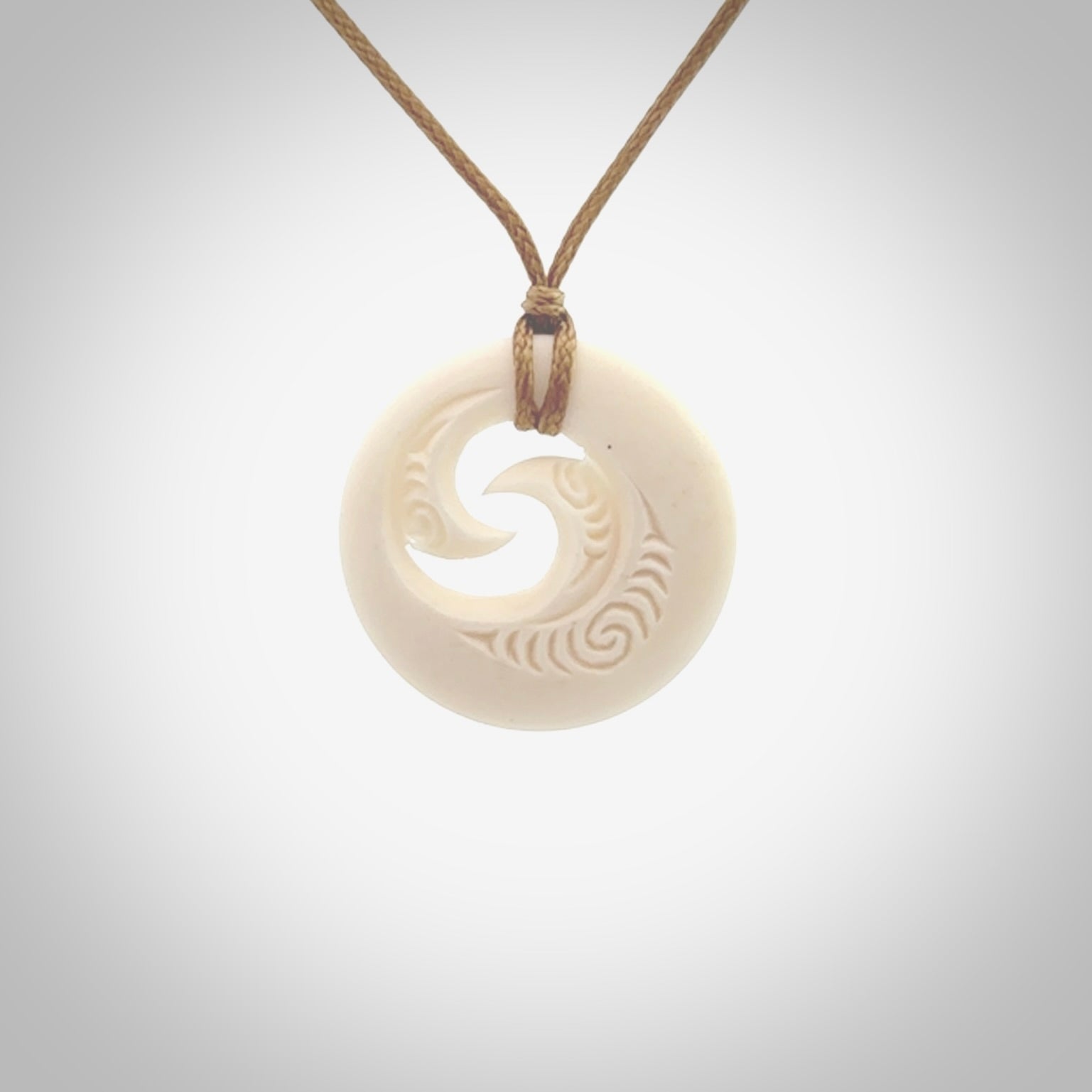A hand carved and engraved koru pendant carved for us by Yuri Terenyi. These are beautiful little pieces are emblematic of the well known and loved Koru design. Provided with an adjustable cord and packaged in a woven kete pouch. Free worldwide delivery.
