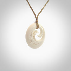 A hand carved and engraved koru pendant carved for us by Yuri Terenyi. These are beautiful little pieces are emblematic of the well known and loved Koru design. Provided with an adjustable cord and packaged in a woven kete pouch. Free worldwide delivery.