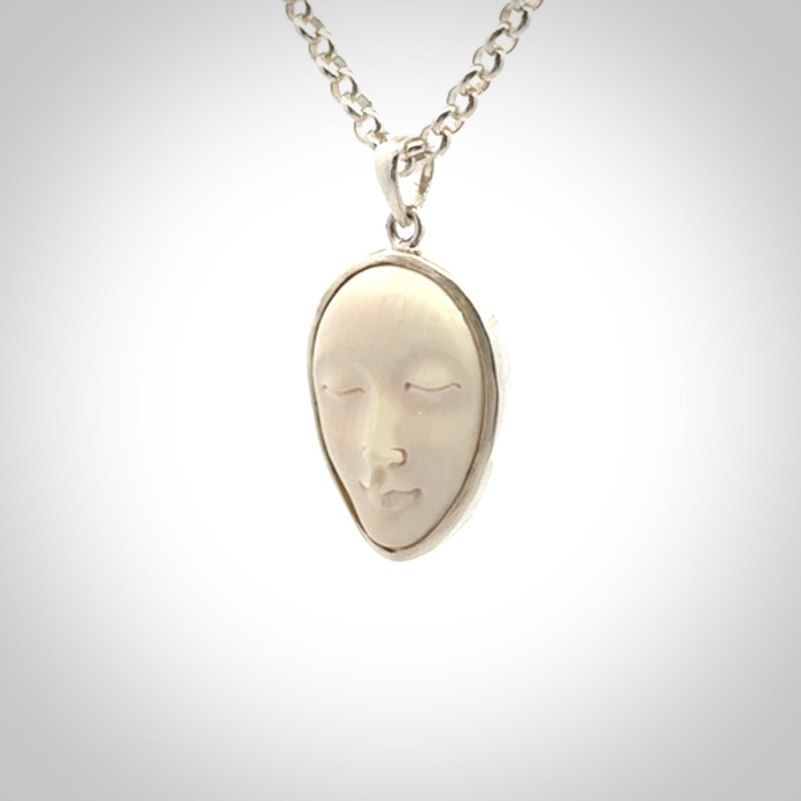 Hand made woolly mammoth tusk moon face necklace. Made by NZ Pacific and sale online only.