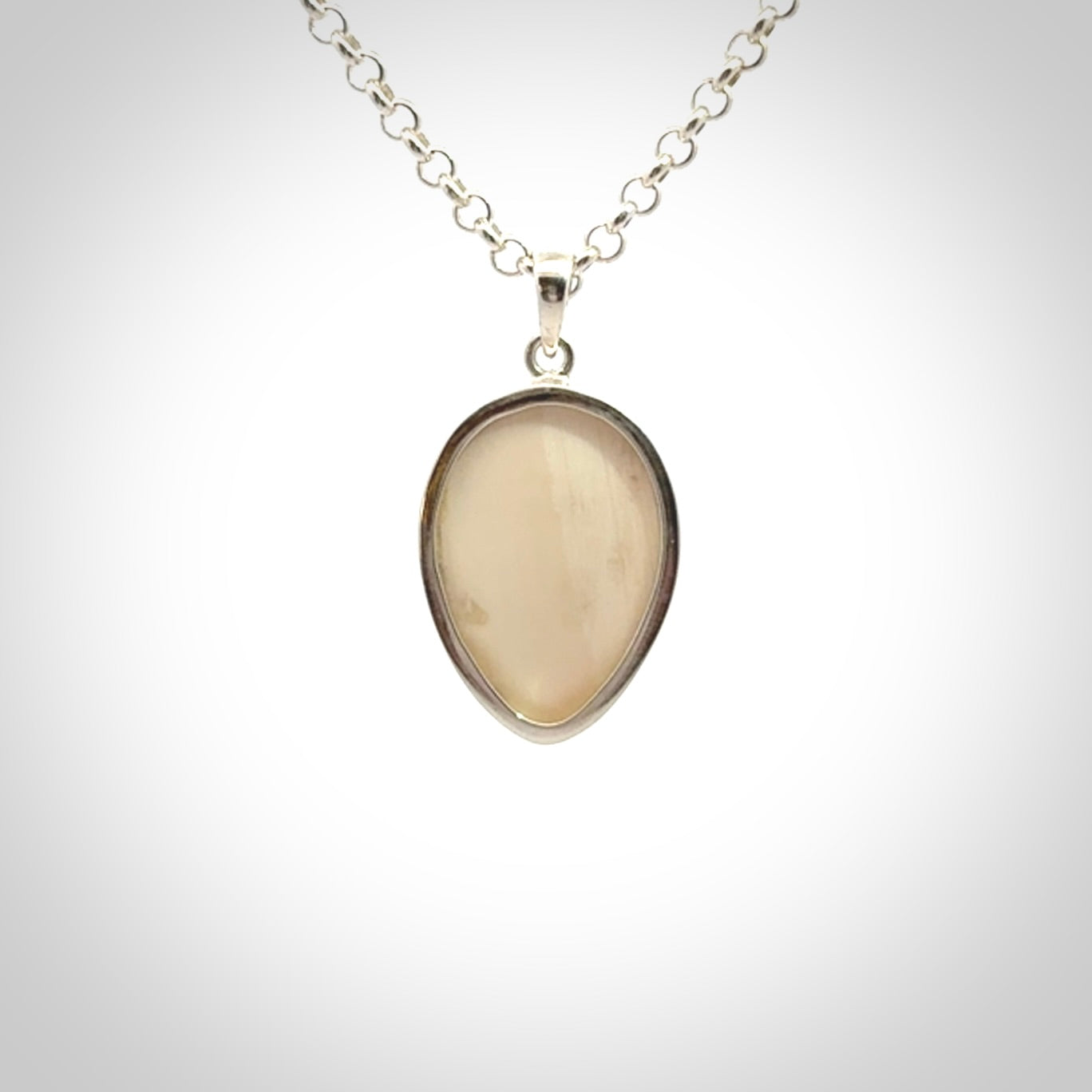 Hand made woolly mammoth tusk moon face necklace. Made by NZ Pacific and sale online only.