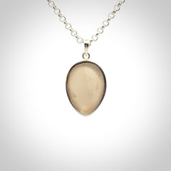 Hand made woolly mammoth tusk moon face necklace. Made by NZ Pacific and sale online only.