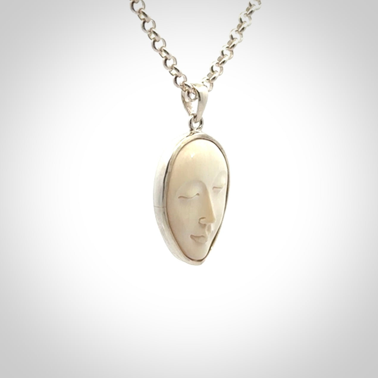Hand made woolly mammoth tusk moon face necklace. Made by NZ Pacific and sale online only.