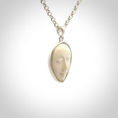 Hand made woolly mammoth tusk moon face necklace. Made by NZ Pacific and sale online only.