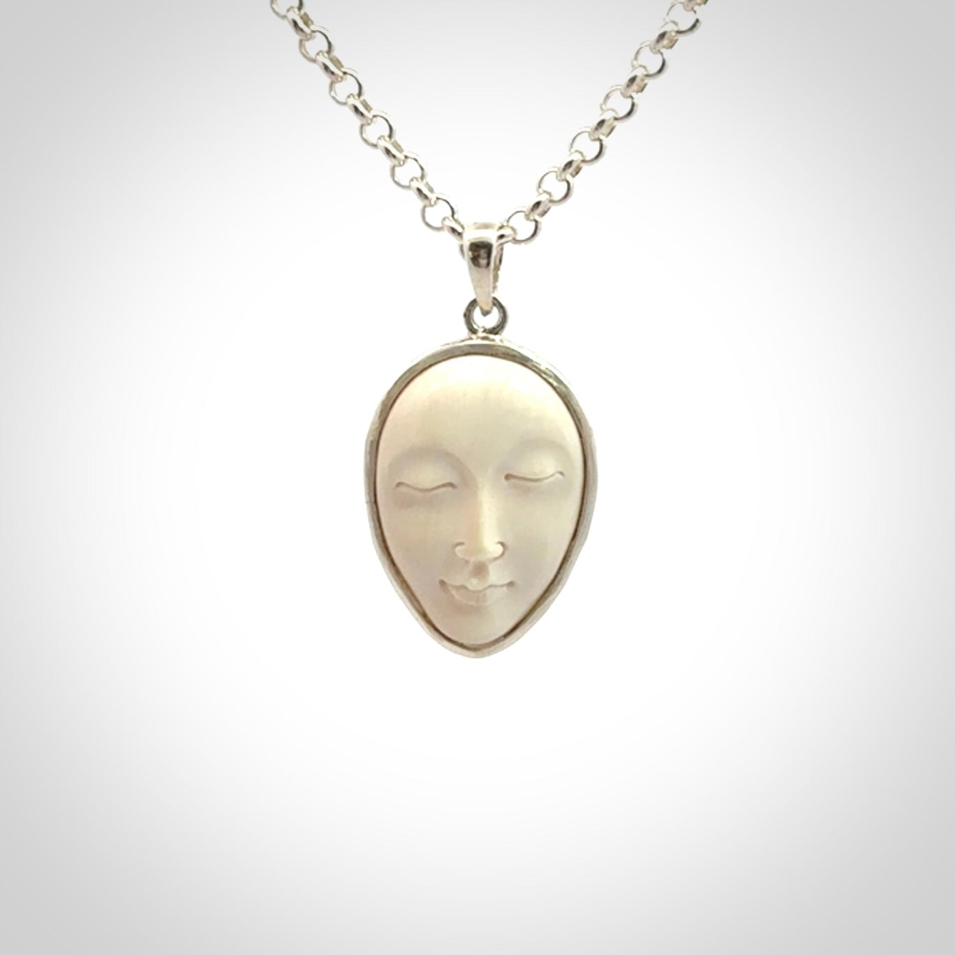Hand made woolly mammoth tusk moon face necklace. Made by NZ Pacific and sale online only.